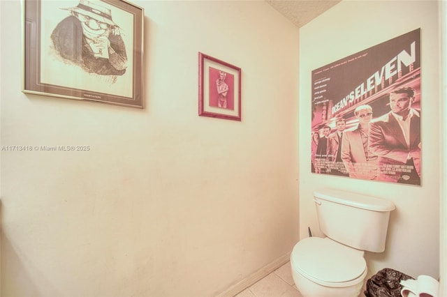 bathroom featuring tile patterned floors, a textured ceiling, and toilet