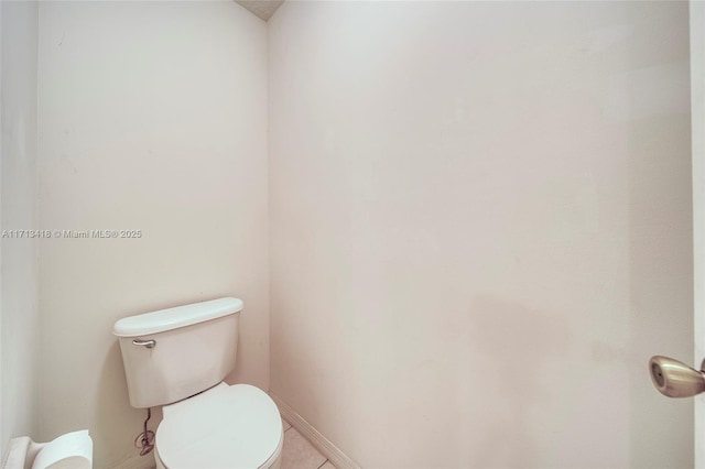 bathroom with tile patterned flooring and toilet