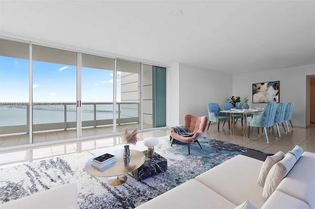 tiled living room featuring expansive windows and a water view