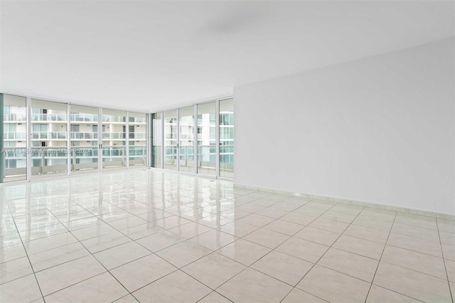 unfurnished room featuring floor to ceiling windows and light tile patterned floors