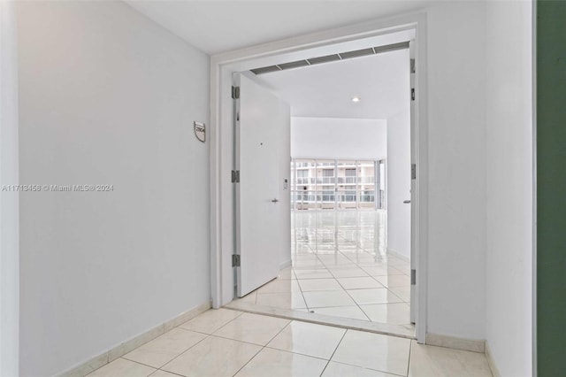 hall featuring light tile patterned floors