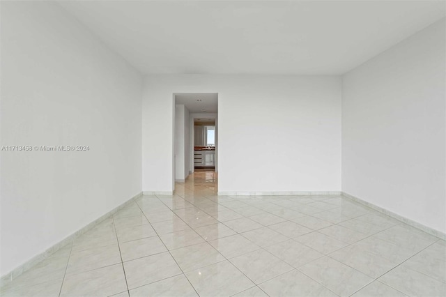 unfurnished room with light tile patterned floors