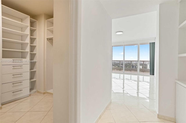 walk in closet with light tile patterned floors