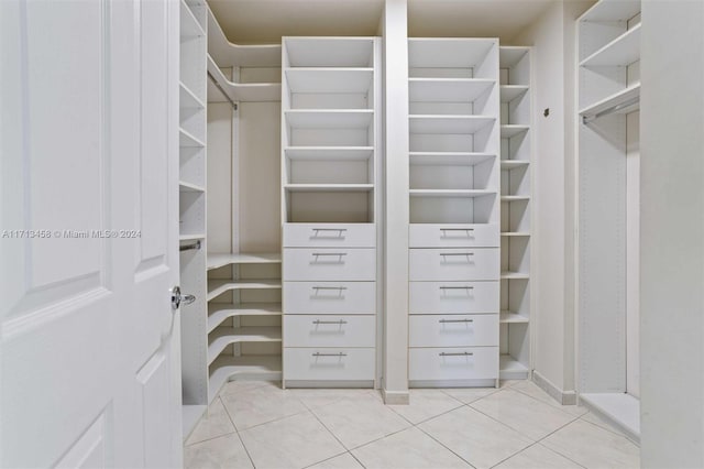 spacious closet with light tile patterned flooring