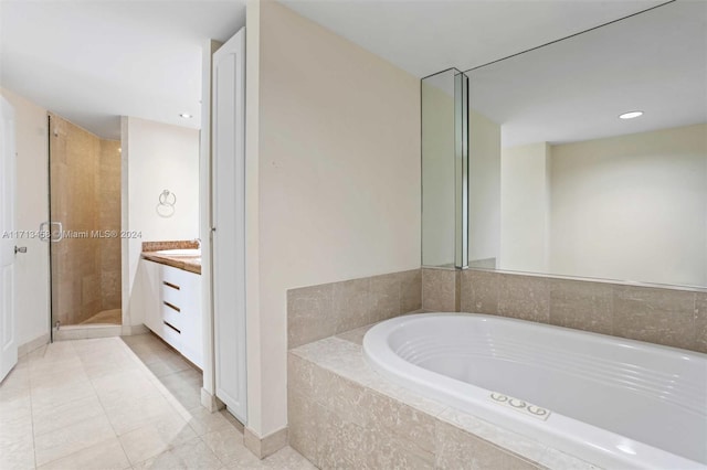 bathroom with tile patterned floors, vanity, and plus walk in shower