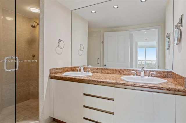 bathroom featuring vanity and a shower with shower door