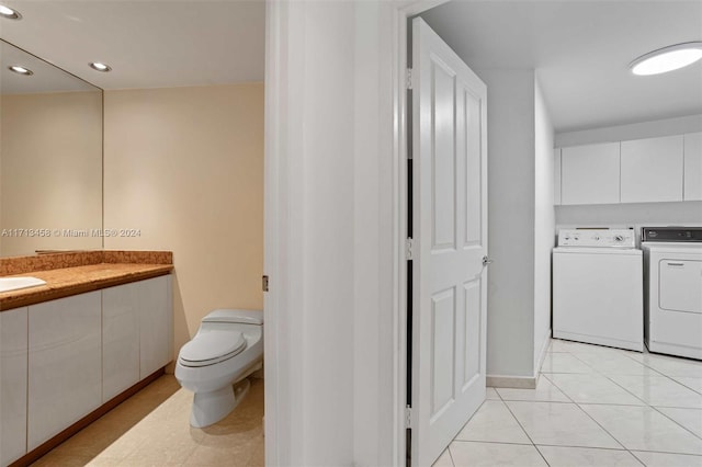 bathroom featuring tile patterned floors, vanity, toilet, and washing machine and clothes dryer