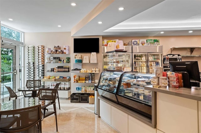 bar with white cabinets and light tile patterned flooring