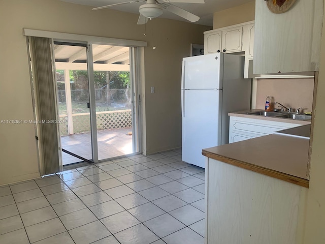 kitchen with ceiling fan, white refrigerator, light tile patterned floors, and sink