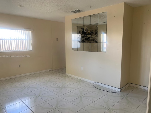 spare room with a textured ceiling