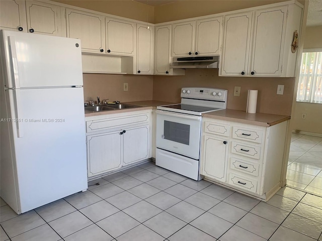 kitchen featuring white cabinets, light tile patterned floors, white appliances, and sink