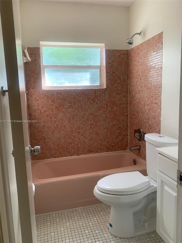 full bathroom with toilet, vanity, tiled shower / bath combo, and tile patterned floors