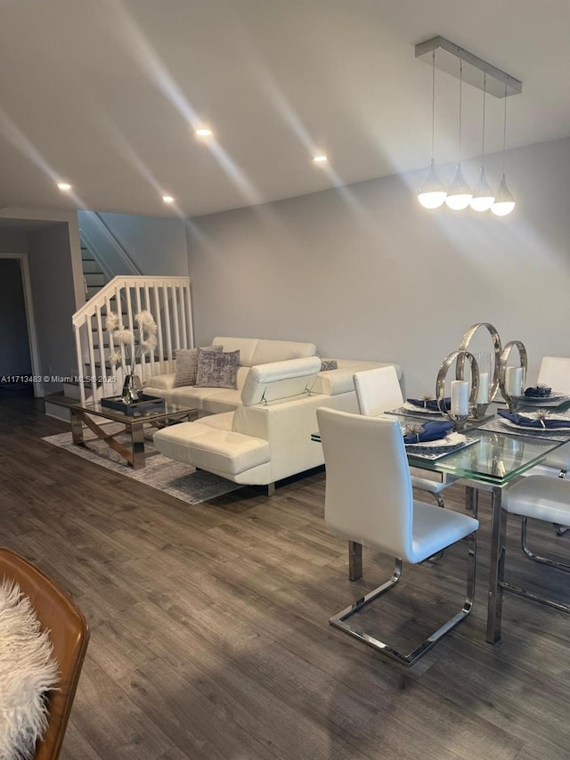 dining area featuring recessed lighting, wood finished floors, and stairway