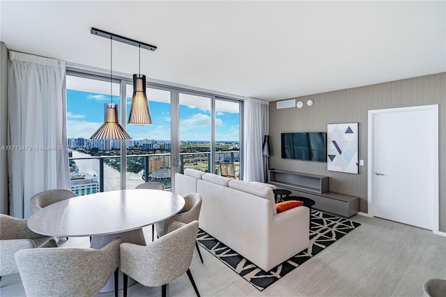 living room with a water view and floor to ceiling windows