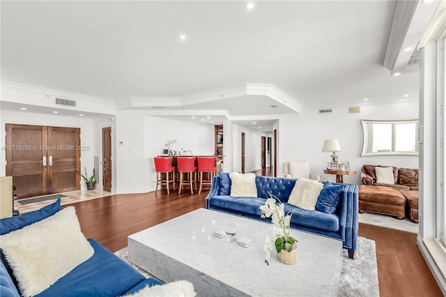 living room featuring dark hardwood / wood-style floors and ornamental molding