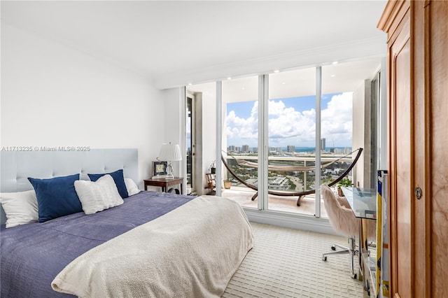 bedroom featuring floor to ceiling windows and ornamental molding