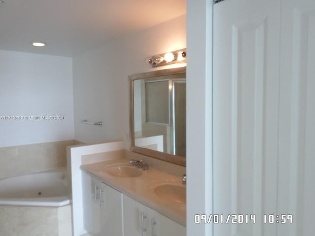 bathroom with a bath and vanity