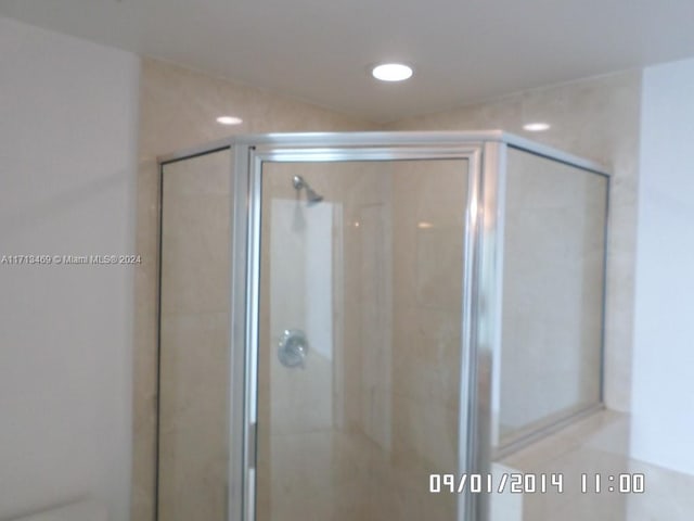 bathroom featuring a shower with door