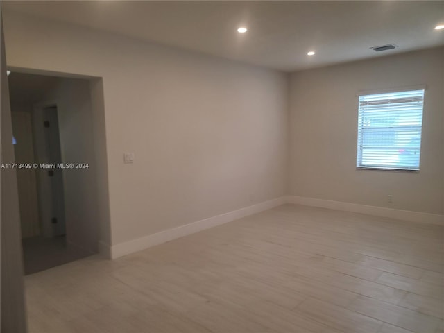 unfurnished room featuring light hardwood / wood-style flooring