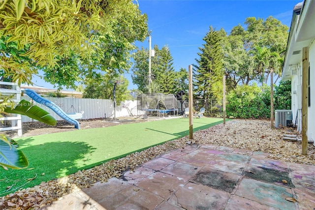 view of patio featuring a trampoline and central air condition unit