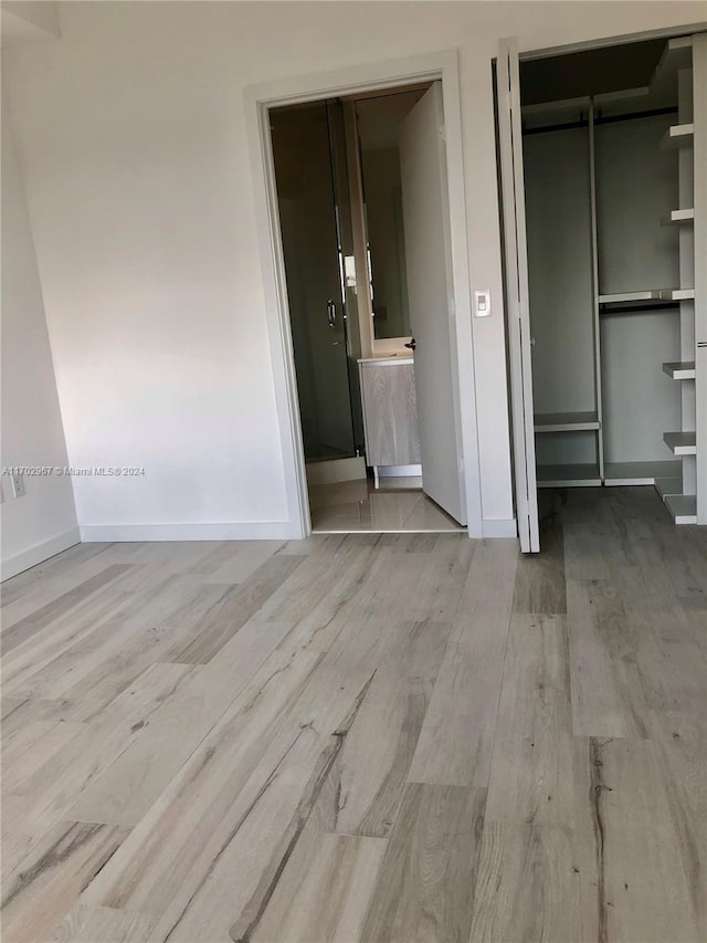 unfurnished bedroom with light wood-type flooring