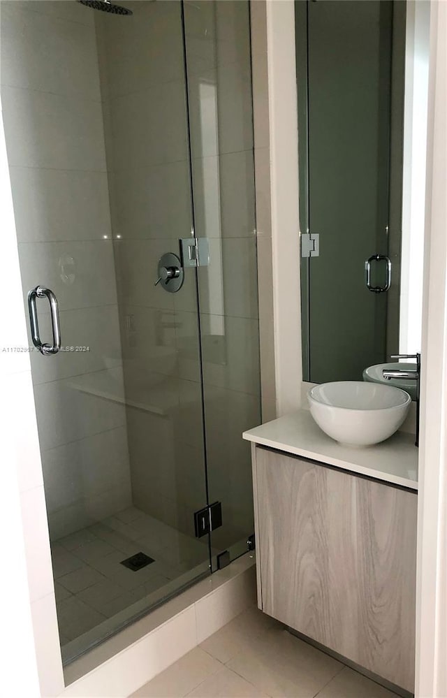 bathroom with vanity, tile patterned floors, and a shower with door