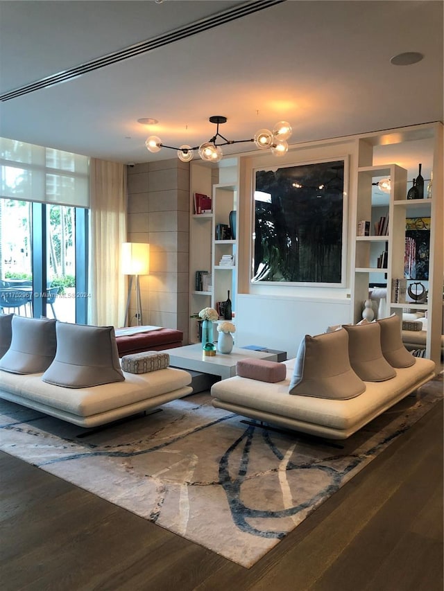 living room featuring dark hardwood / wood-style flooring and built in features