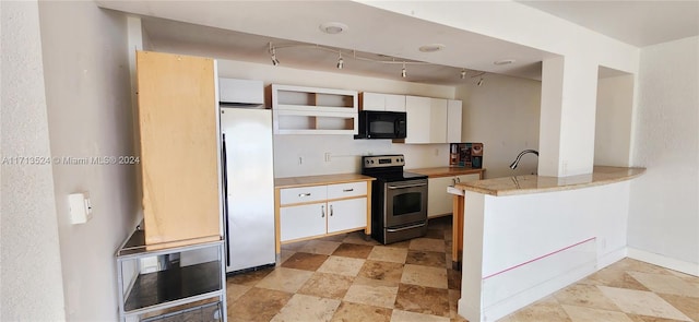 kitchen featuring kitchen peninsula, appliances with stainless steel finishes, rail lighting, and white cabinetry