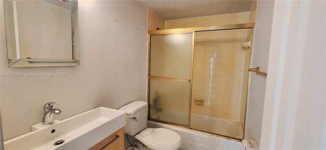 full bathroom with toilet, vanity, and combined bath / shower with glass door