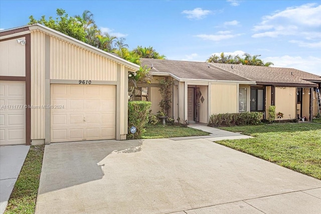 ranch-style home featuring a garage and a front lawn