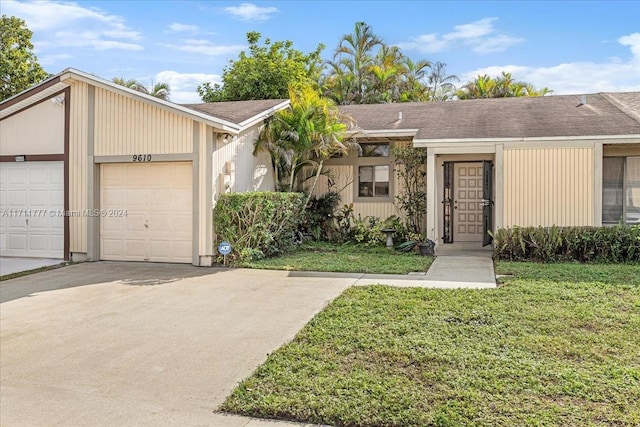 ranch-style house with a front yard and a garage