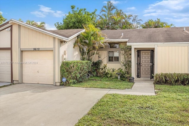 view of front of property with a garage and a front yard