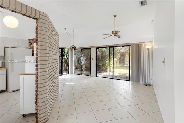 unfurnished living room with light tile patterned floors and ceiling fan