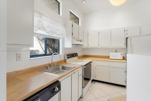 kitchen with white cabinets, white appliances, light tile patterned flooring, and sink