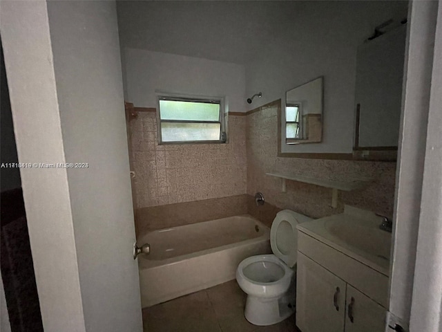 full bathroom featuring tile patterned floors, vanity, toilet, and tiled shower / bath