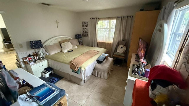 bedroom featuring light tile patterned flooring