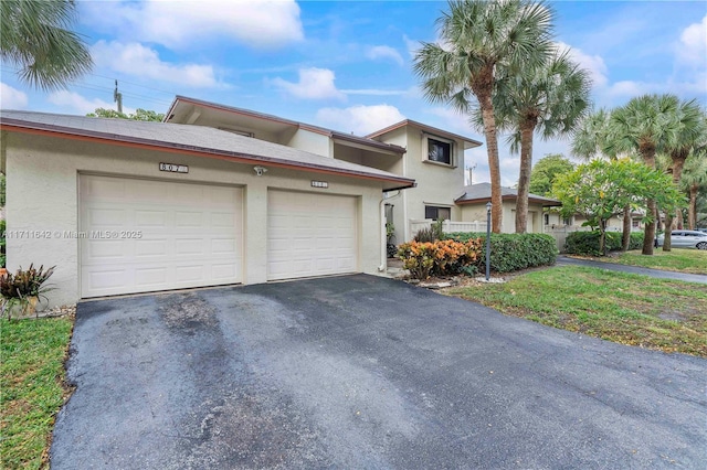 townhome / multi-family property with stucco siding and a garage