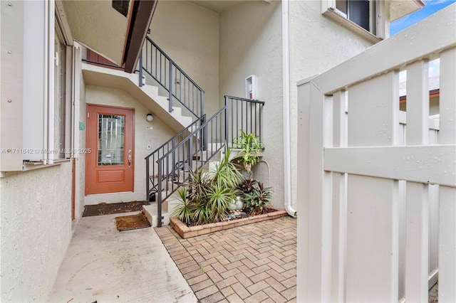 entrance to property featuring stucco siding and a patio