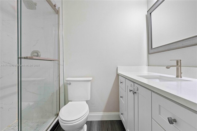 1750 NE 39th Ct Unit 808, Pompano Beach, FL 33064 - bathroom featuring baseboards, a marble finish shower, toilet, and vanity