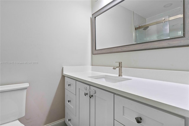 1750 NE 39th Ct Unit 808, Pompano Beach, FL 33064 - bathroom featuring toilet, vanity, a shower with shower door, and baseboards