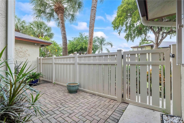 view of patio with a gate and fence