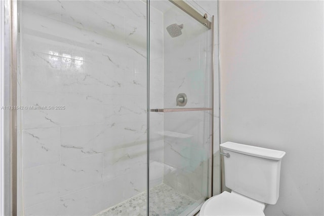 full bath featuring a marble finish shower and toilet