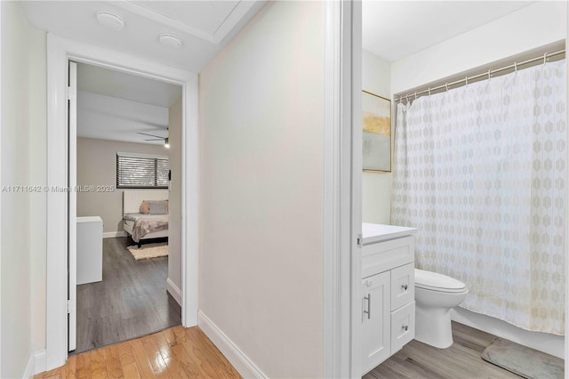 1750 NE 39th Ct Unit 808, Pompano Beach, FL 33064 - full bath featuring wood finished floors, vanity, toilet, baseboards, and connected bathroom