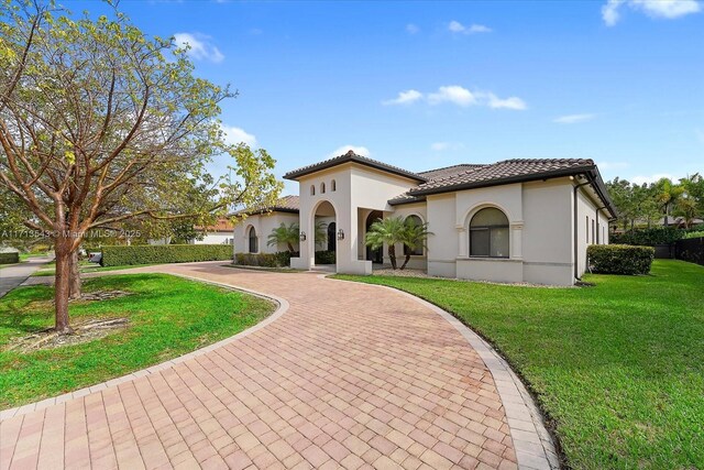 mediterranean / spanish house with a front lawn