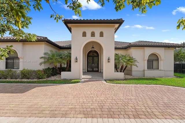 mediterranean / spanish home featuring french doors