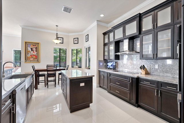 kitchen featuring dishwasher, wall chimney exhaust hood, decorative light fixtures, backsplash, and a kitchen island