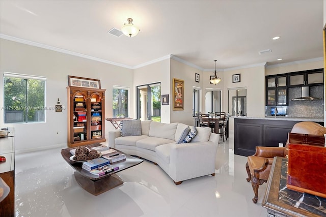 living room featuring ornamental molding and a wealth of natural light