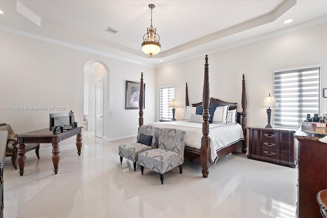 bedroom with crown molding and a raised ceiling