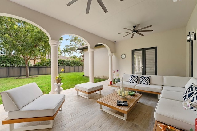 view of patio / terrace with french doors, an outdoor living space, and ceiling fan