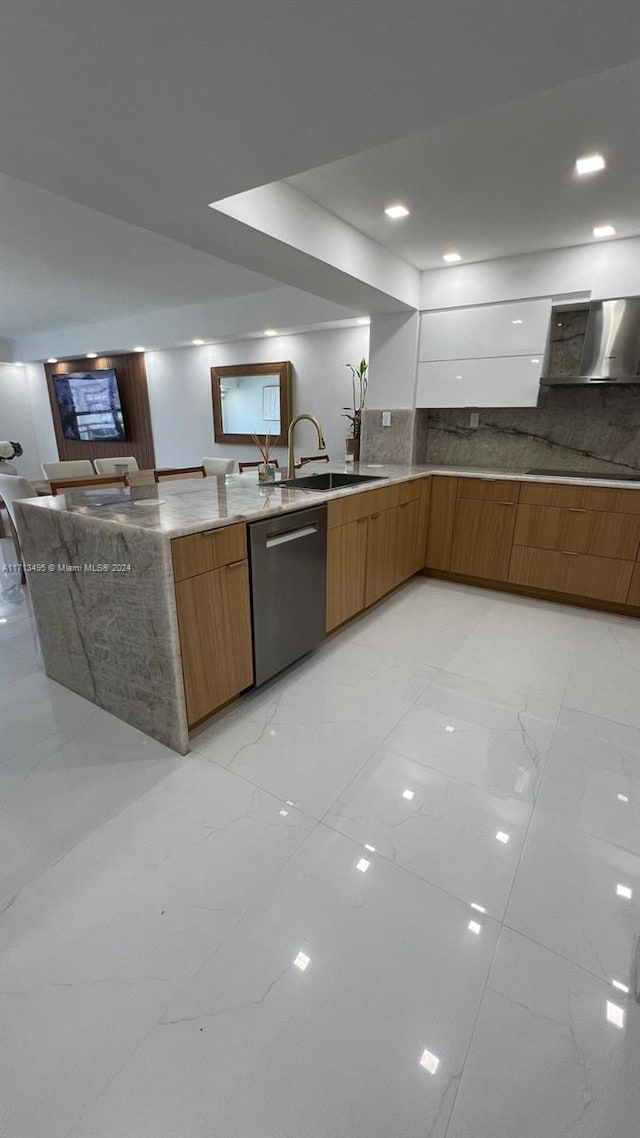 kitchen with black electric stovetop, backsplash, stainless steel dishwasher, sink, and wall chimney range hood